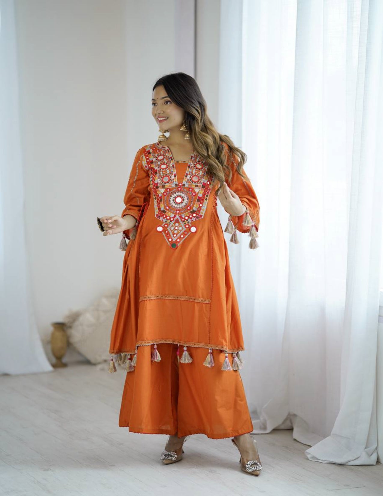 Orange Peplum Style Suit With Foil Mirror Work and tassels
